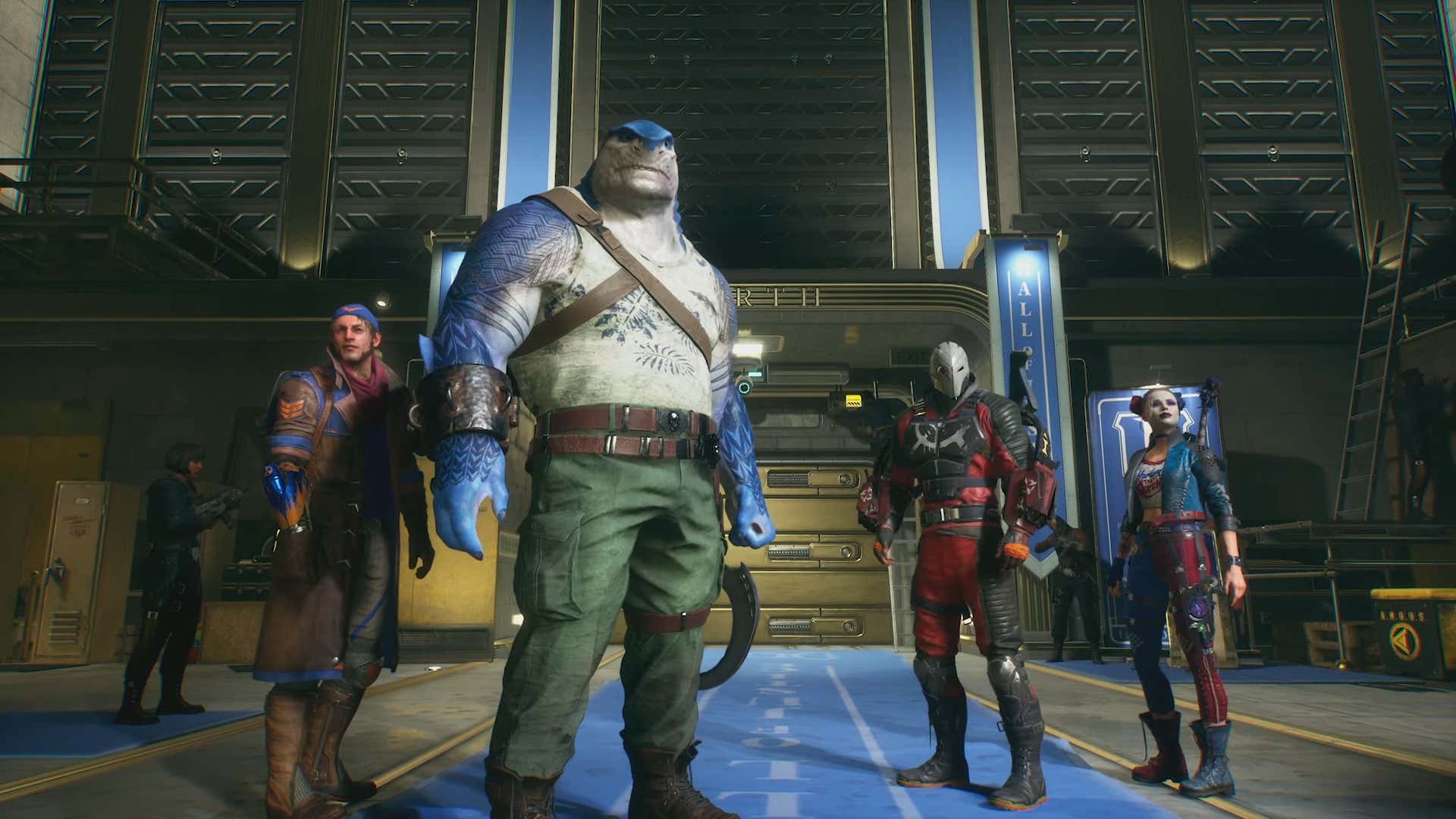 A screenshot shows the Suicide Squad standing side by side in the Hall of Justice. 